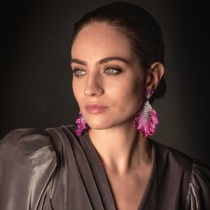 Woman wearing Chopard diamond jewellery.