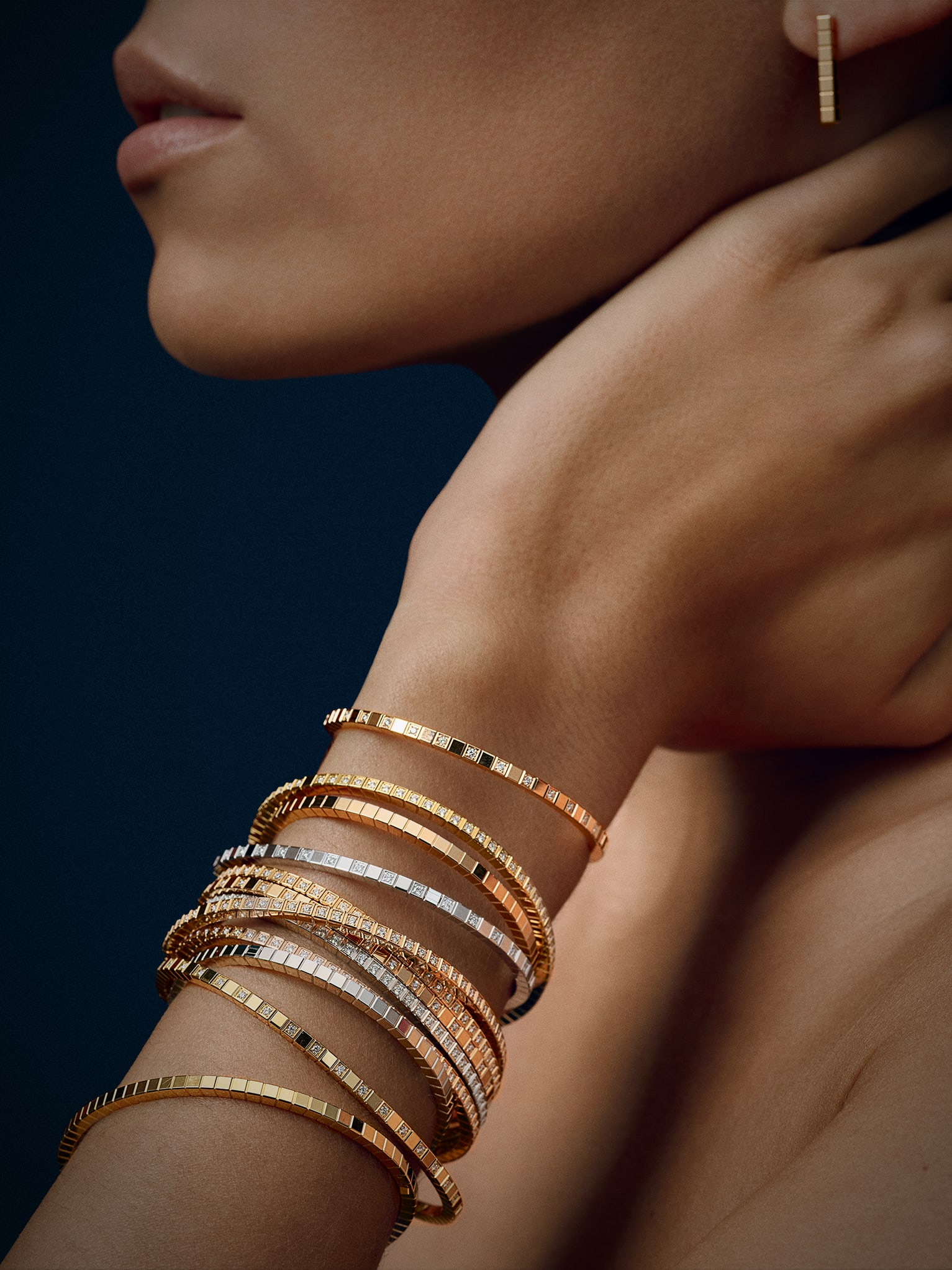 Woman wearing  Ice Cube gold bangles 